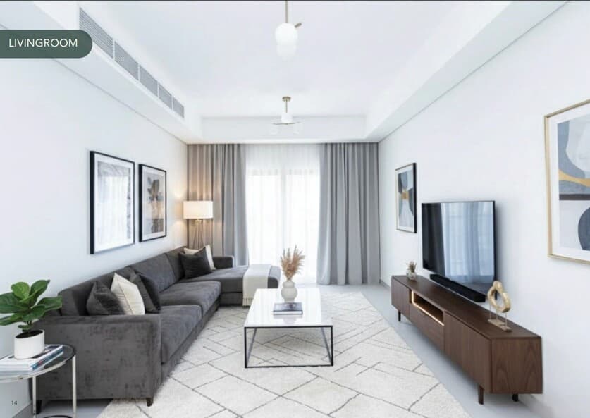 Azha View Residences Ajman main entrance with sculptural canopy, multi-storey podium parking and palm-lined boulevard