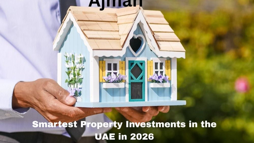 a person holding a colorful model of house in a hand shows property investment in Ajman will get beneficial 