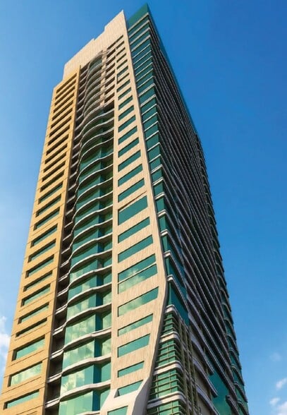 Modern fully-fitted kitchen in Azha View Residences Ajman apartment with navy cabinetry, gas range, and washing machine
