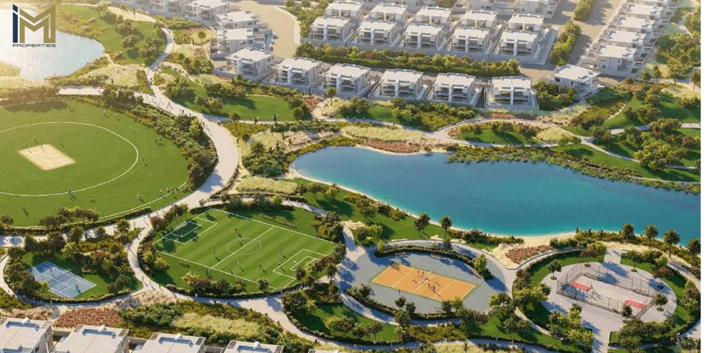 An aerial view of Damac Hills 2 (Akoya Oxygen), showcasing lush greenery, sports facilities, a serene lake, and luxurious villa clusters, highlighting its sustainable and family-friendly environment.