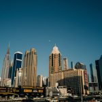 A panoramic view of Dubai's skyline, featuring modern skyscrapers and busy streets. This image can be used to highlight the diverse range of properties available in the UAE, including budget-friendly options.