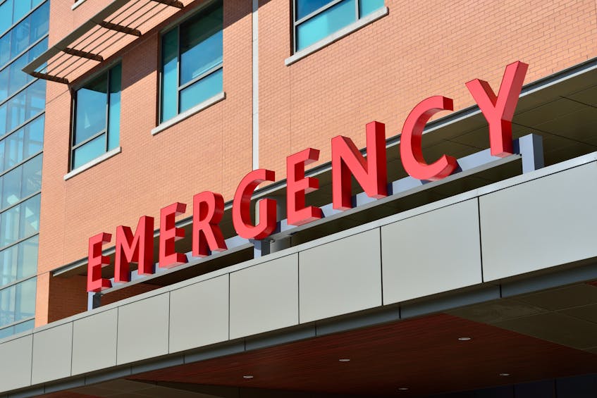 Emergency department entrance of a hospital in Al Bustan, Ajman, with bold red 'EMERGENCY' signage on a modern building