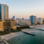 Ajman building on beach, showcasing ARRA's role in regulating the real estate market in Ajman