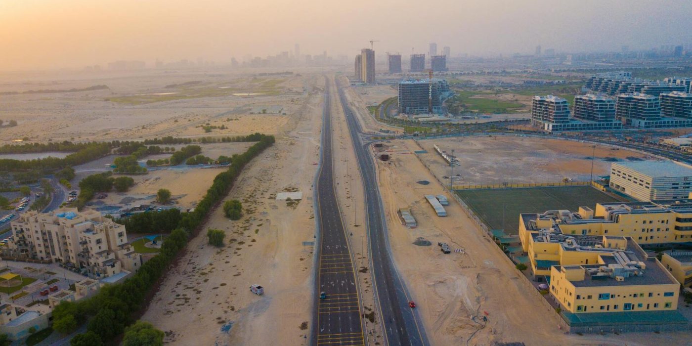 an ariel view of al yasmeen ajman shows villas and low-rise buildings in this community