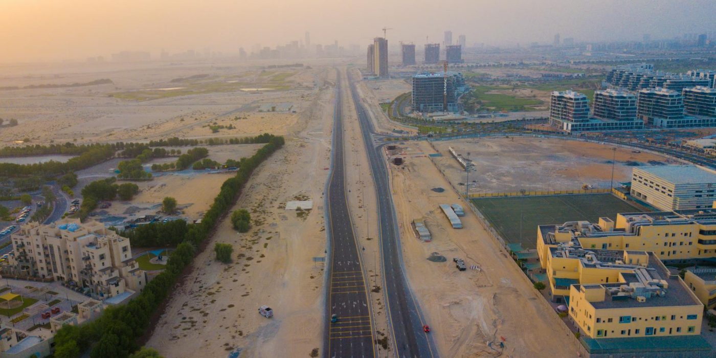 an ariel view of al yasmeen ajman shows villas and low-rise buildings in this community