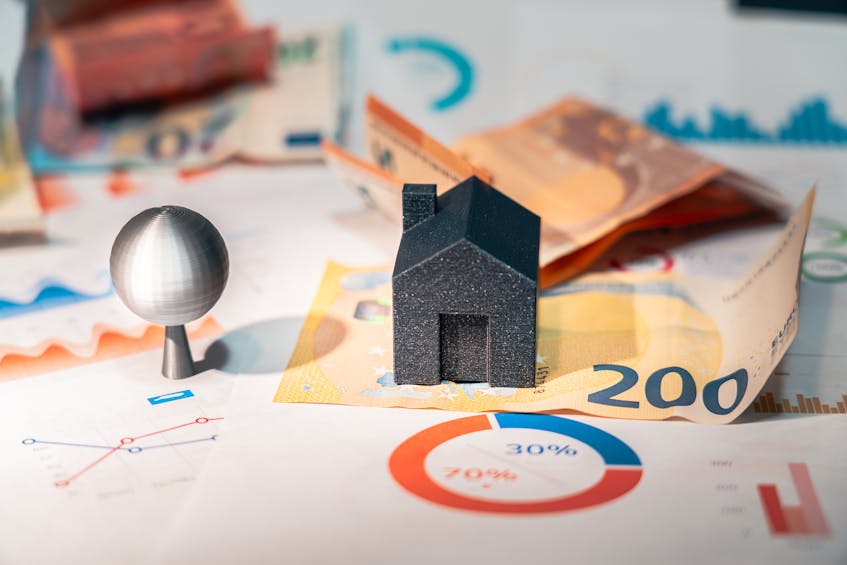 Dubai real estate market trends concept with financial charts, euro banknotes, and miniature house model, symbolizing property investment and market analysis