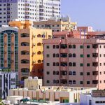 Skyline view of rent-to-own apartments in Ajman, showcasing modern residential buildings in a growing real estate market. Ideal for buyers looking for flexible homeownership options.