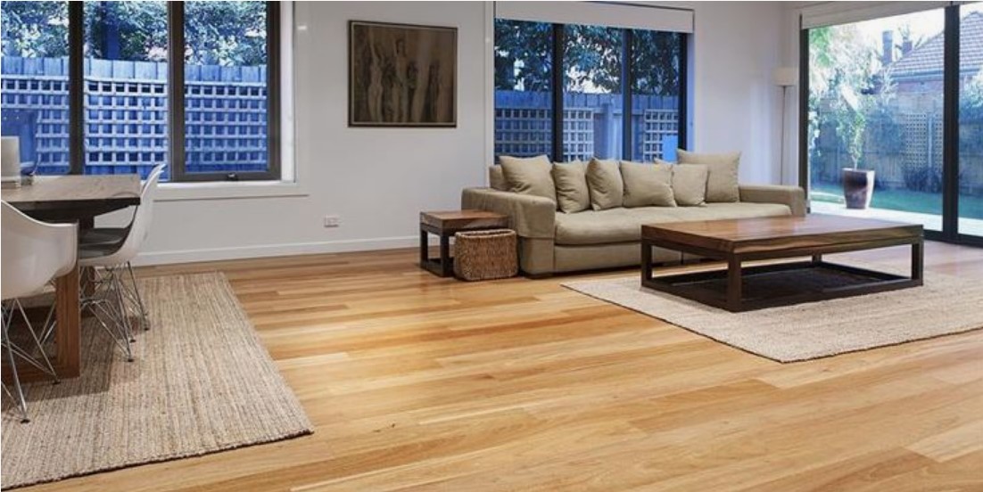 the wooden floor in the lounge of an apartment is affordable flooring solution to make the space elegant