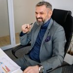 a man in office estimating the cost and procedures of setting up a business in Ajman
