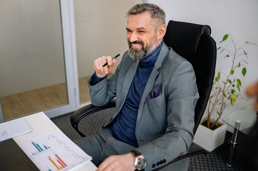 a man in office estimating the cost and procedures of setting up a business in Ajman