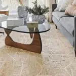 Modern beige textured carpet in a Dubai living room with contemporary furniture and glass coffee table