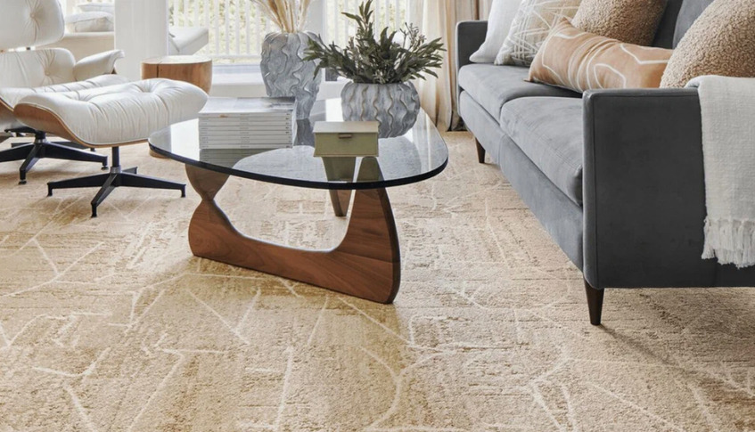 Modern beige textured carpet in a Dubai living room with contemporary furniture and glass coffee table